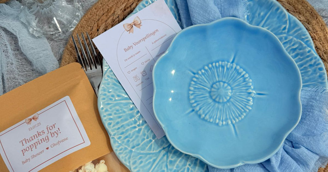 Baby Shower Ideas featuring a blue decorative plate and personalized invitation on a beautifully arranged table.